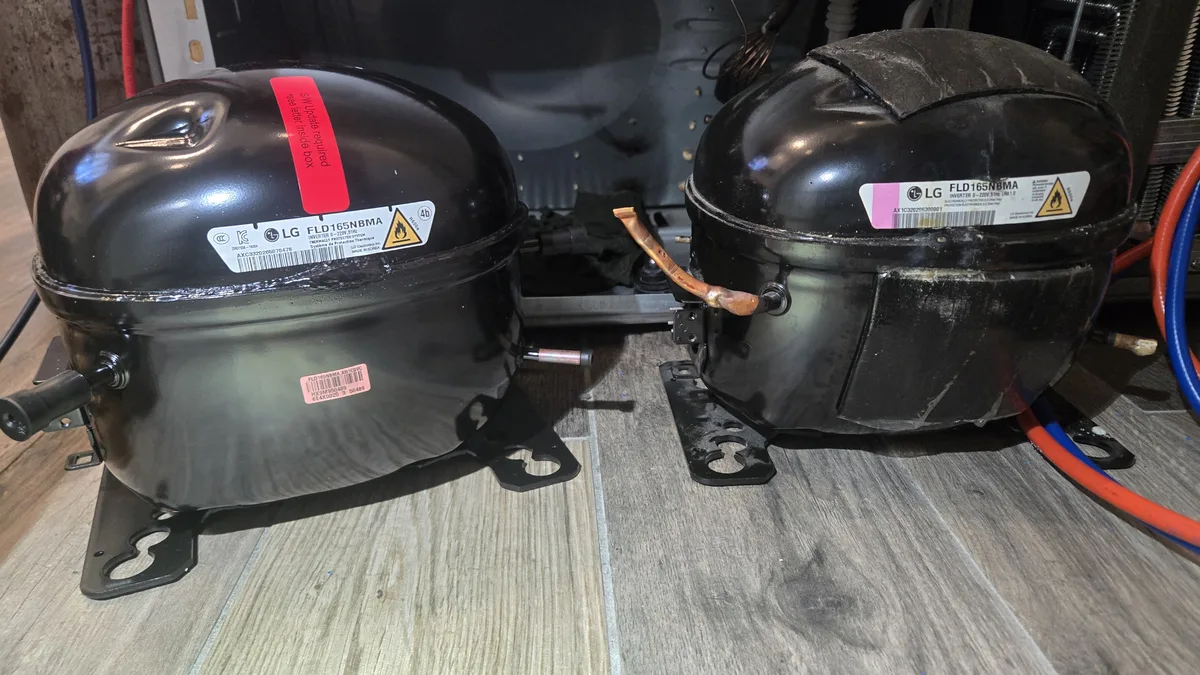 Old and new LG compressors side by side on the floor