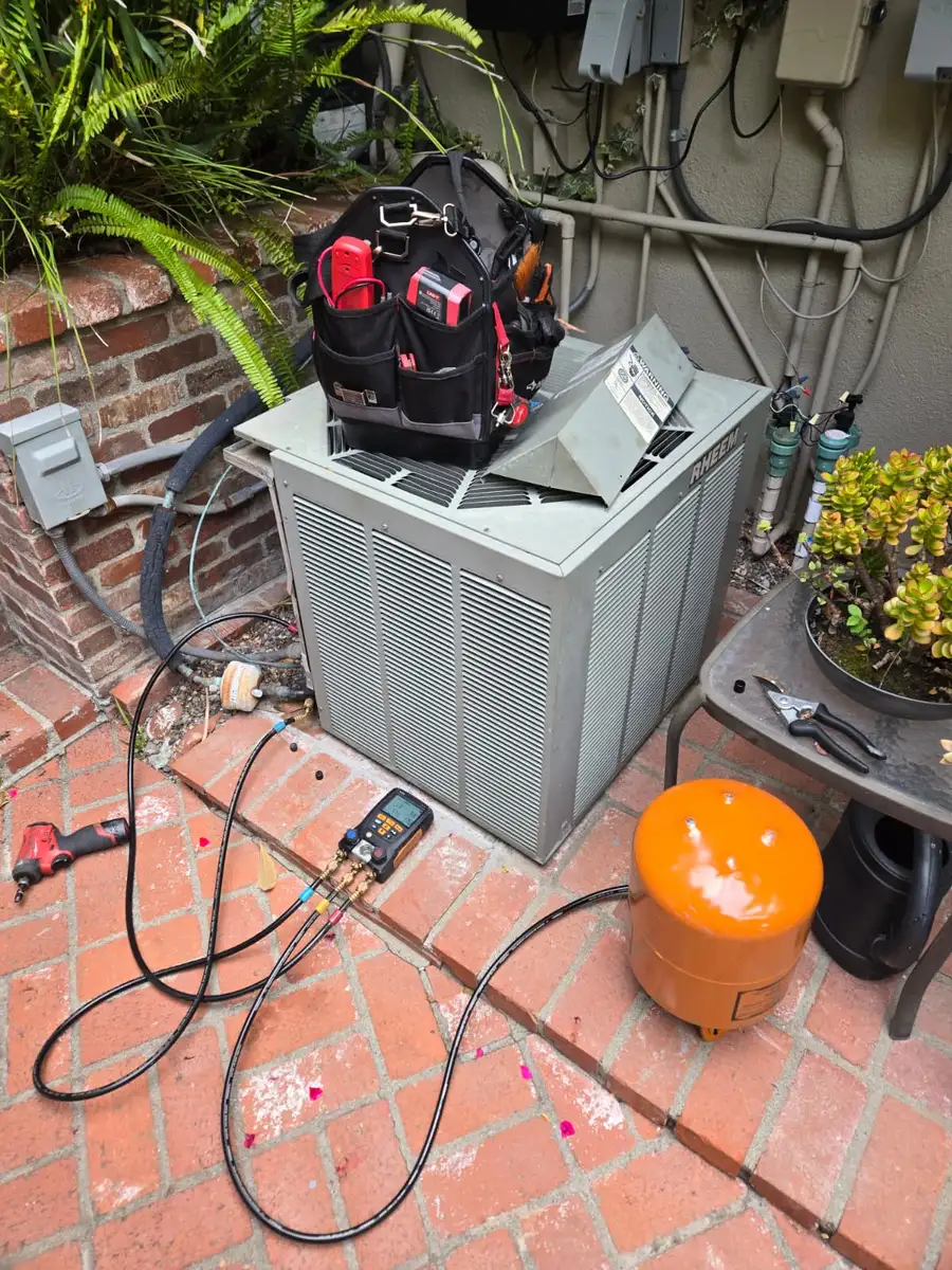 AC condenser serviced with refrigerant gauges on a brick patio by Epic Star in Pacific Palisades, CA