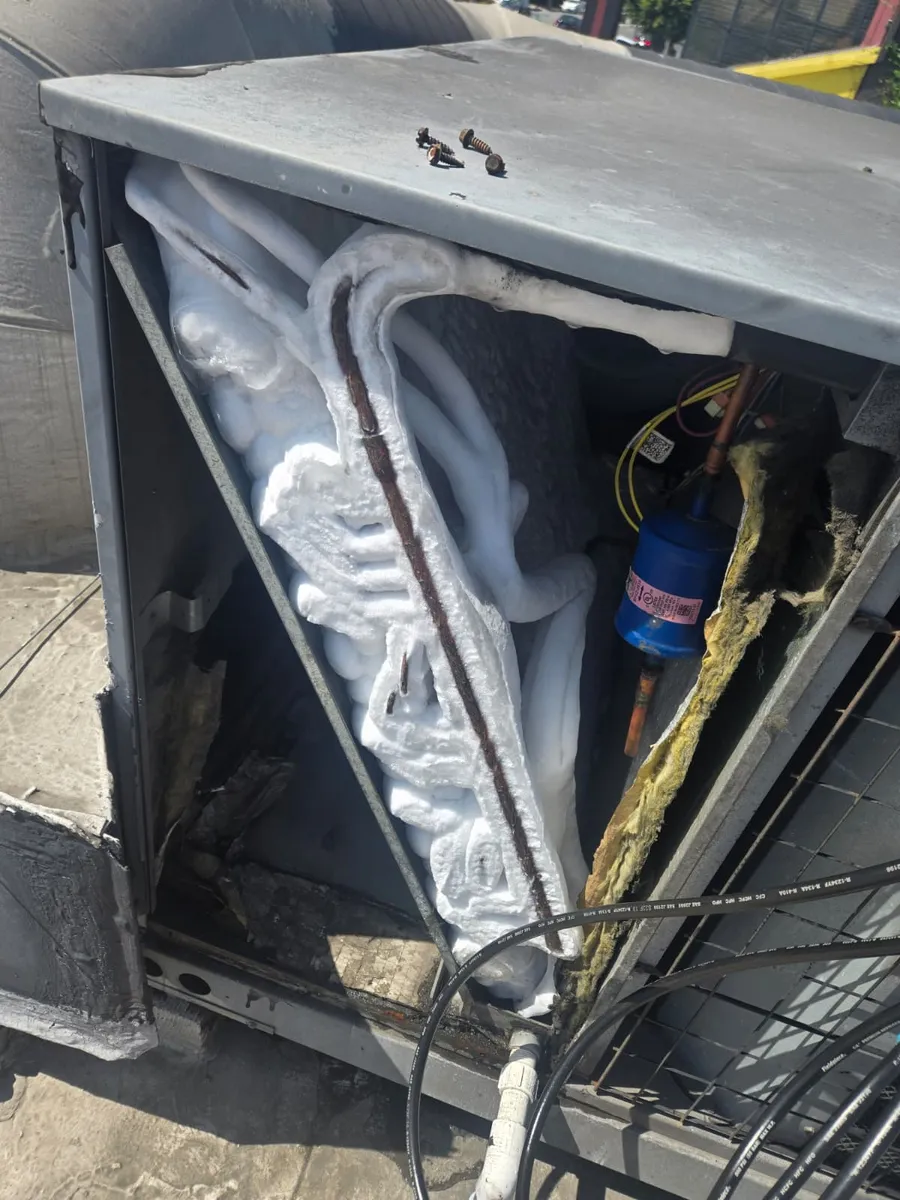 Heavily iced coils on a rooftop commercial refrigeration unit before de-icing by Epic Star in Mid-Wilshire, Los Angeles