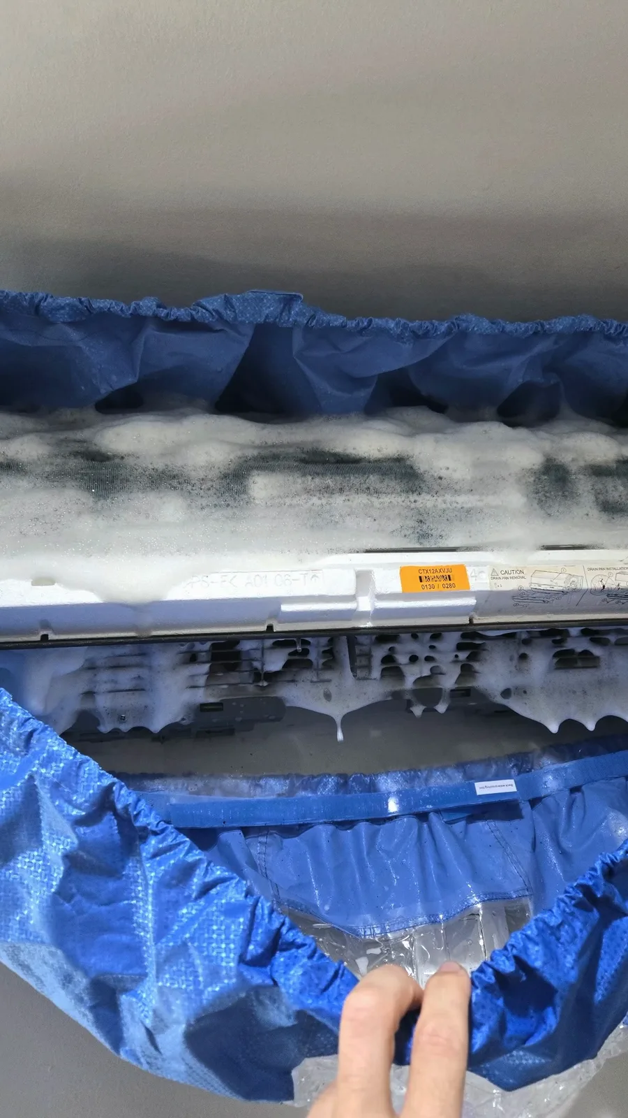 Dirty foam dripping off the coil into the cleaning bag