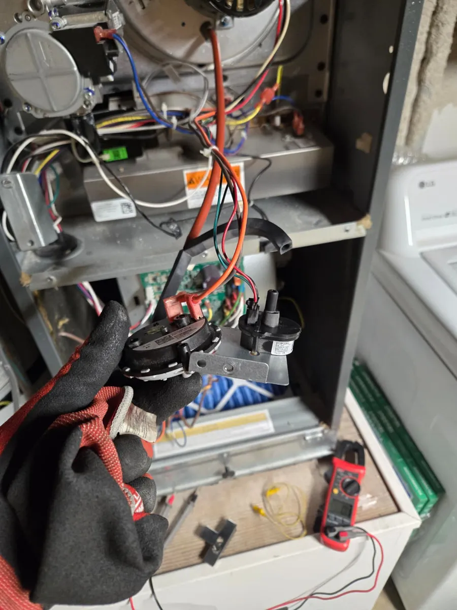 Furnace pressure switch and inducer assembly held by an Epic Star technician in Hancock Park, CA