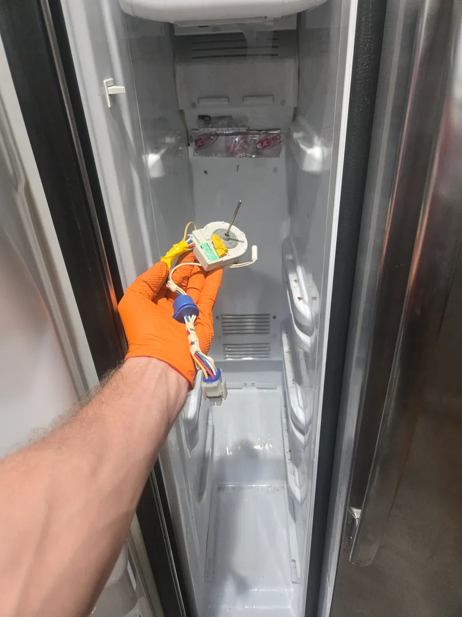 Whirlpool refrigerator evaporator fan assembly held inside the freezer during service